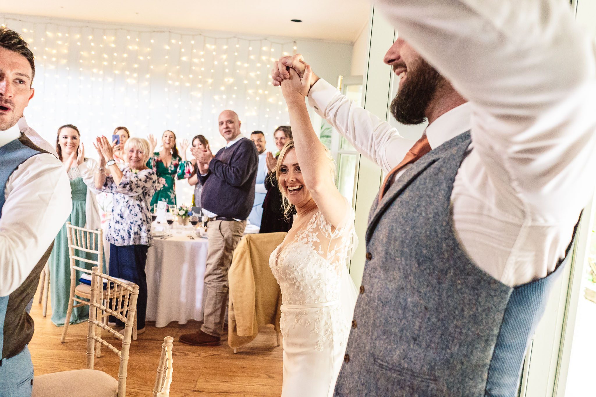 Bride and groom walking into the wedding breakfast