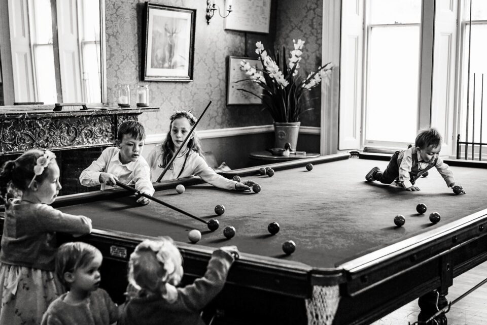 Kids playing on the snooker table at a Penton Park wedding