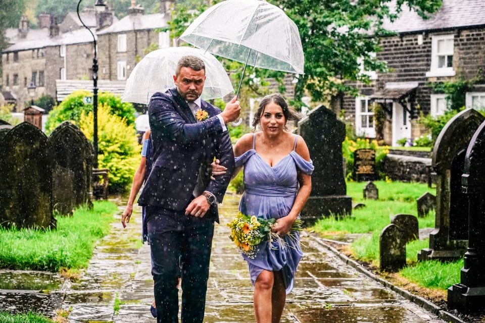 Bridesmaid arriving at the ceremony in the rain