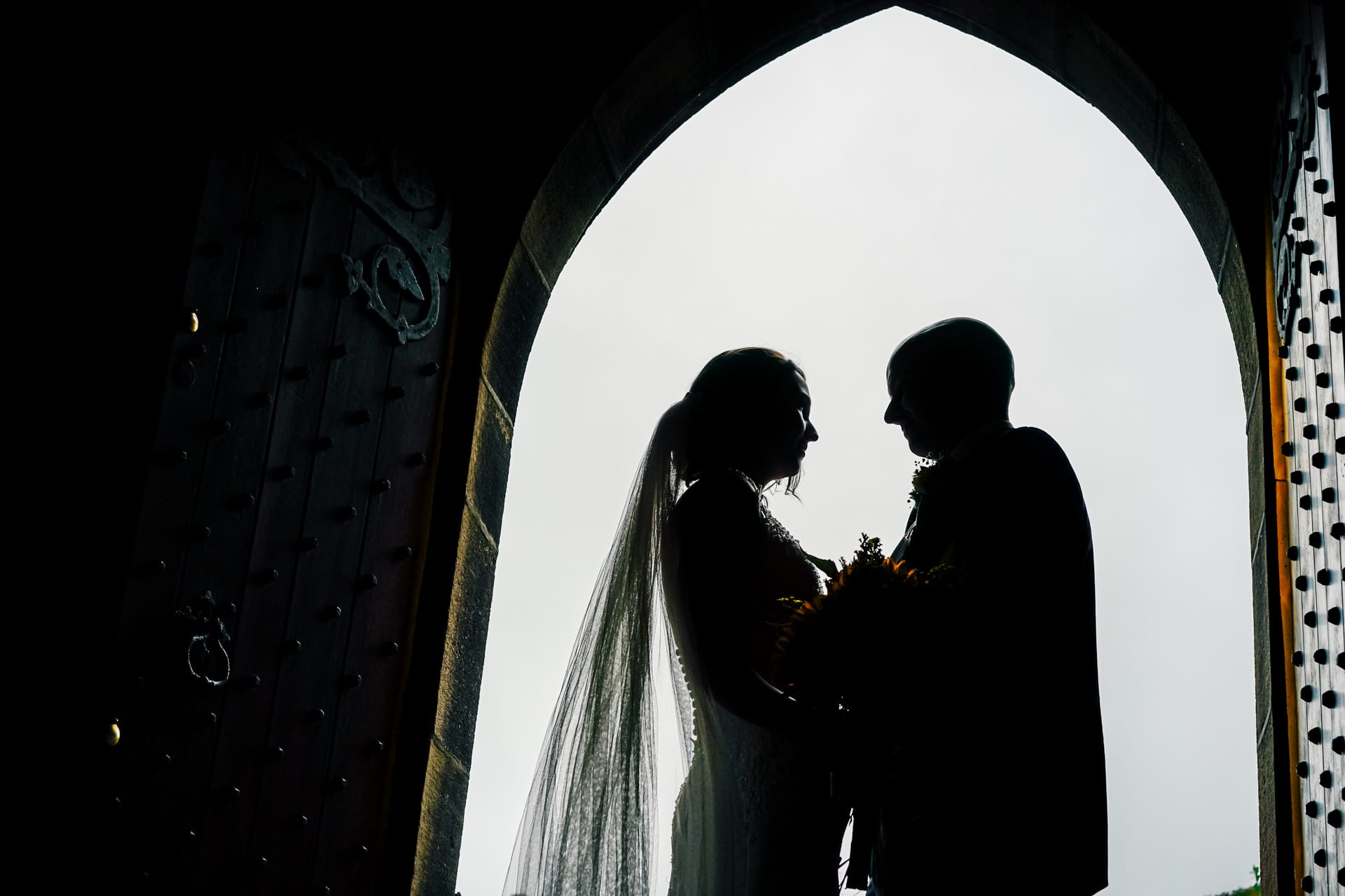 Bride and Groom in silhouette at a Lancashire church door