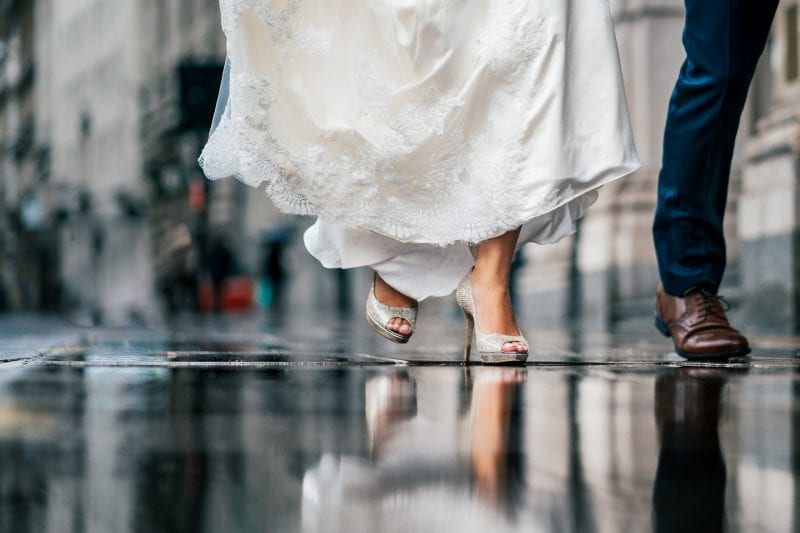 Trinity House Wedding Photographer Bride's wedding shoes on rainy streets at a wedding at 1 Lombard Street in London
