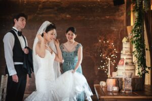 Bride looking at wedding cake at an Elmore Court wedding in Gloucestershire