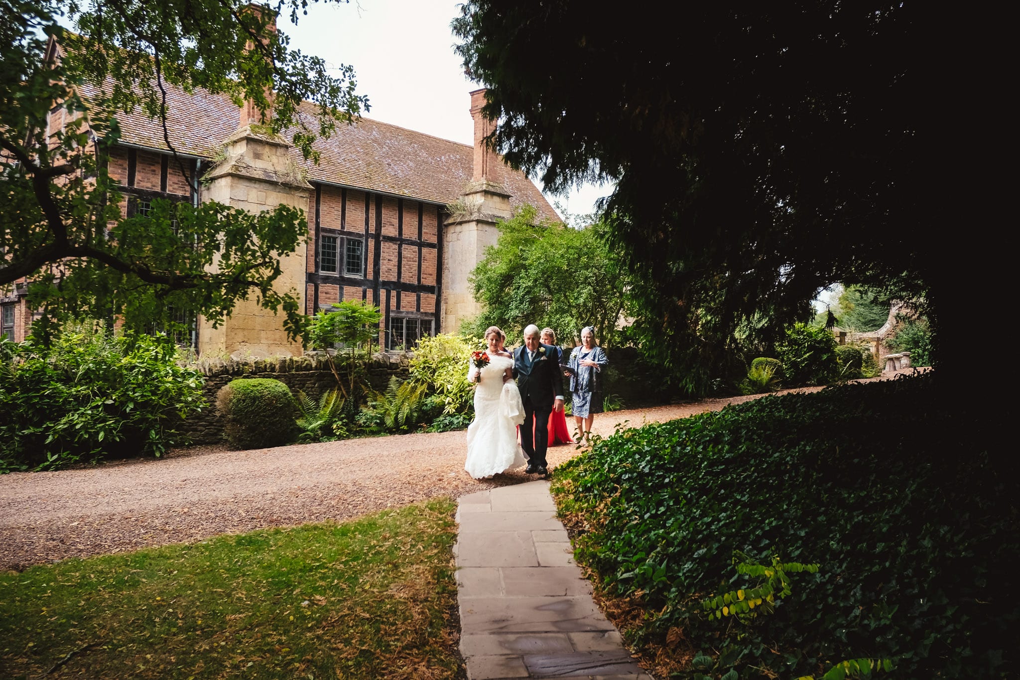 Bride walking to the church at a Birtsmorton Court Wedding