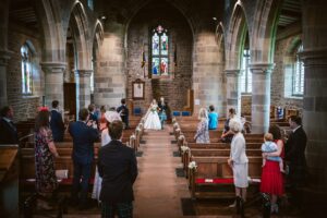 Bride and Father walk down the aisle at a socially distanced wedding in The Lakes