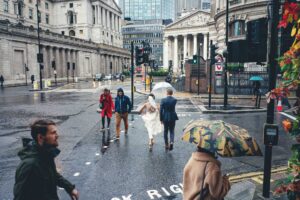 Bride and groom in London in the rain