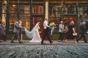 Bride and groom walking to their wedding reception at the Lamb Tavern in London
