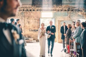 Bride and father walking in at an Asylum Chapel wedding in London