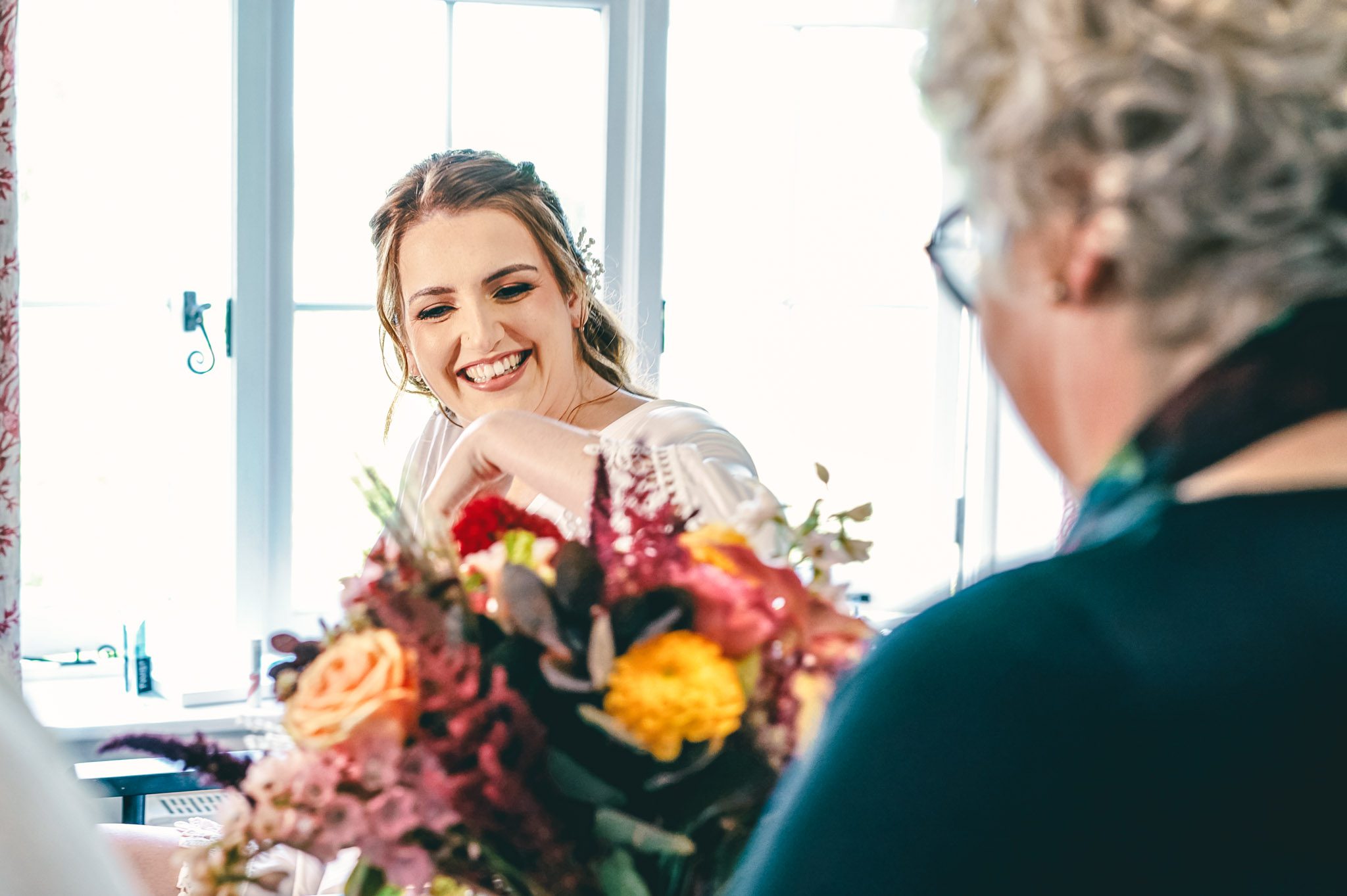Bride seeing her bouquet at a wedding at a Birtsmorton Court wedding in Worcestershire