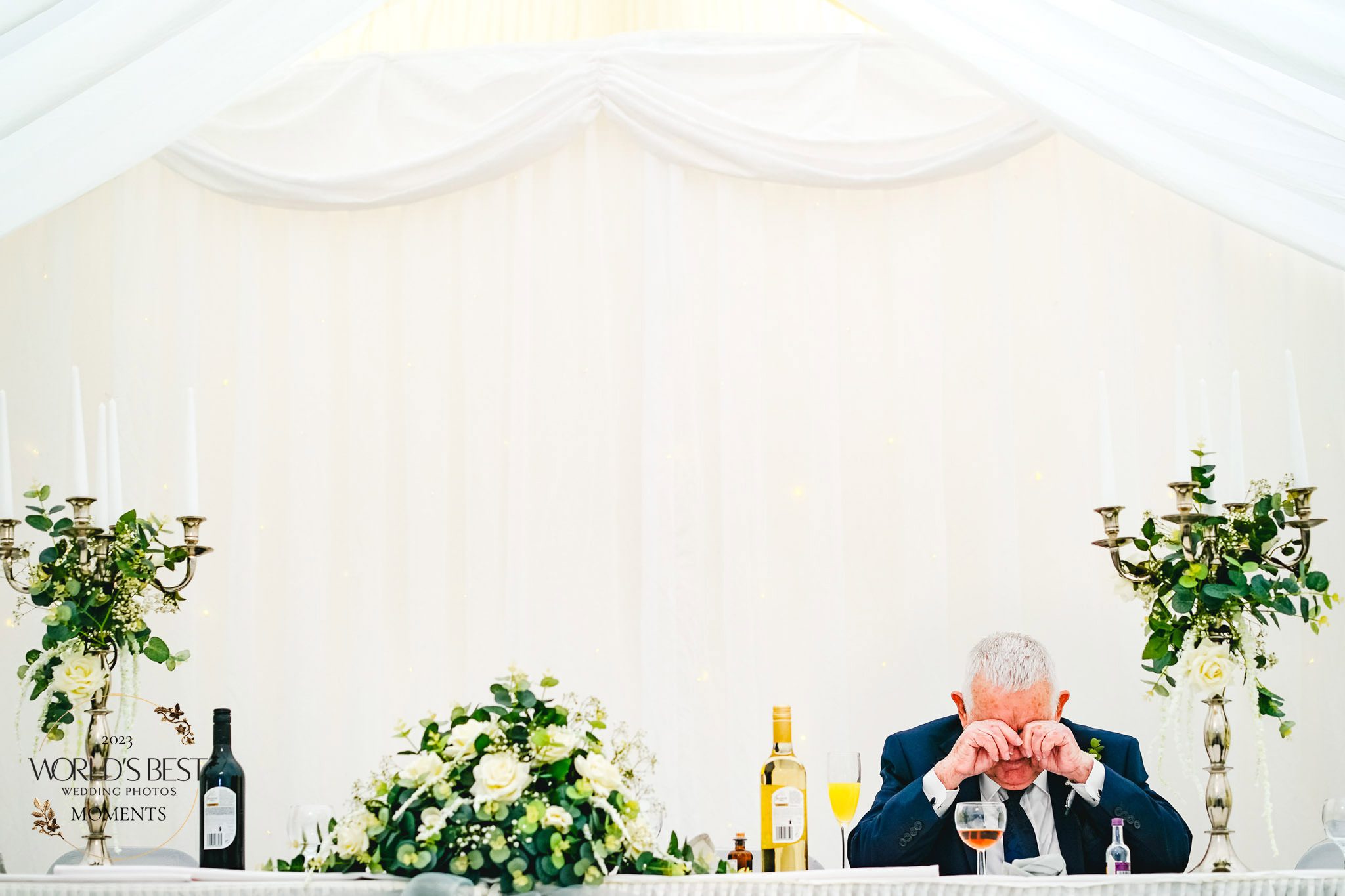 Father crying at the top table of a wedding