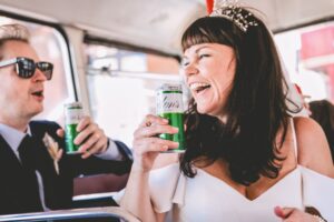 Bride and groom sipping tinned gin at a Micro wedding photography UK. Relaxed documentary photographer Andrew Billington.