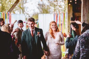 Bride and groom walking back up the aisle at a wedding at La Ferme Du Coudray in France