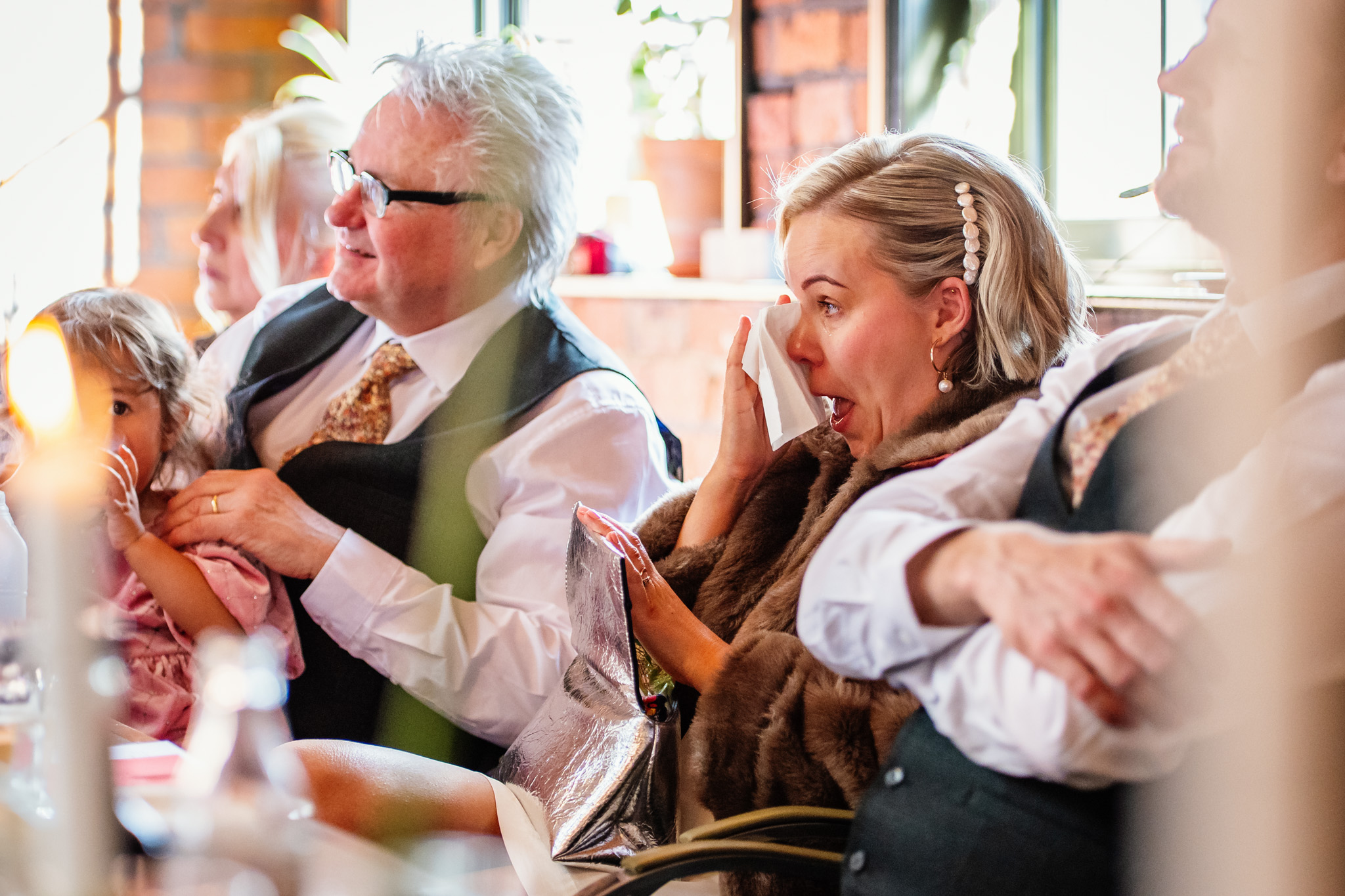The bride dabs a tear at a relaxed Chimney House wedding in Sheffield