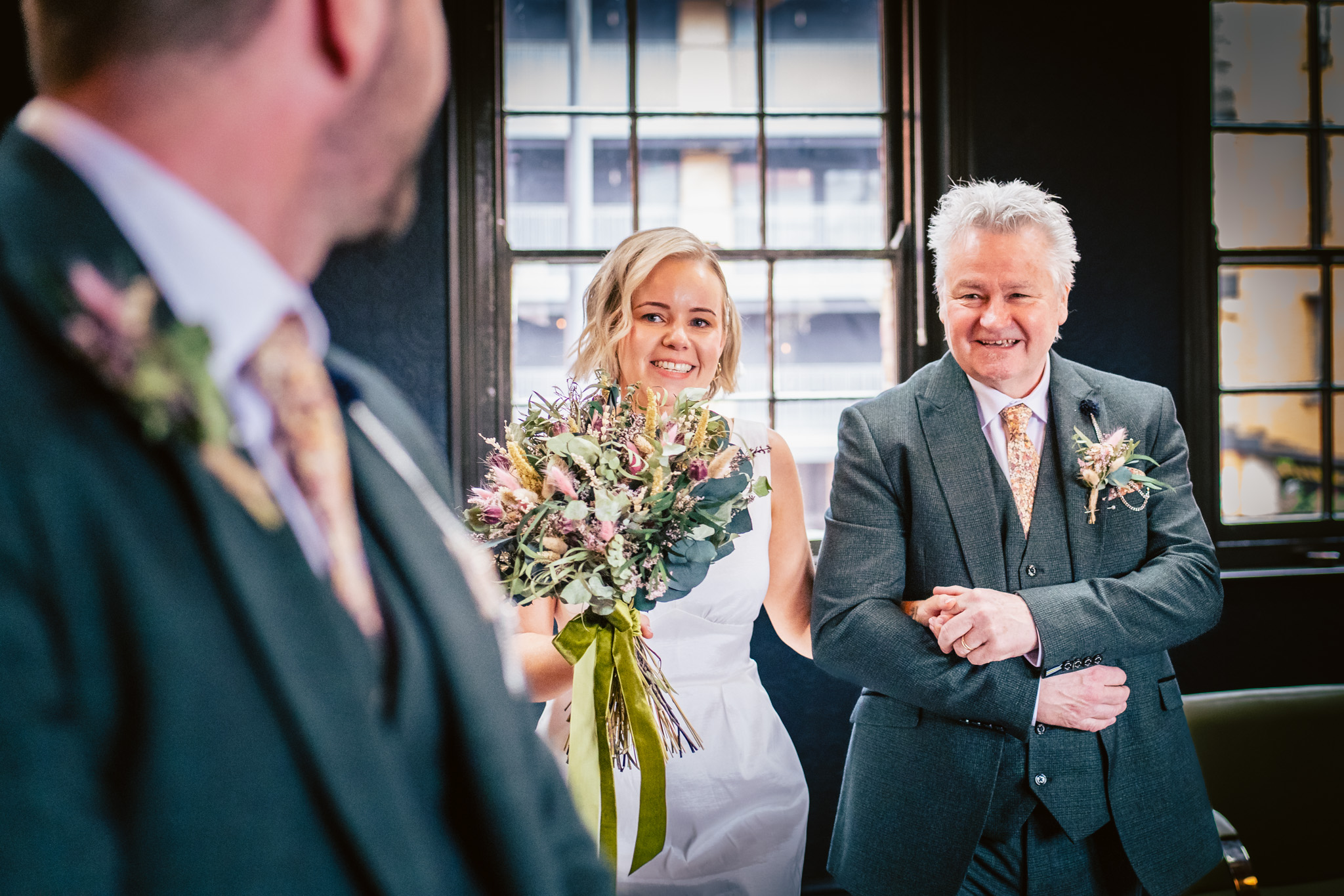Bride and father walk down the aisle at a relaxed Chimney House wedding in Sheffield