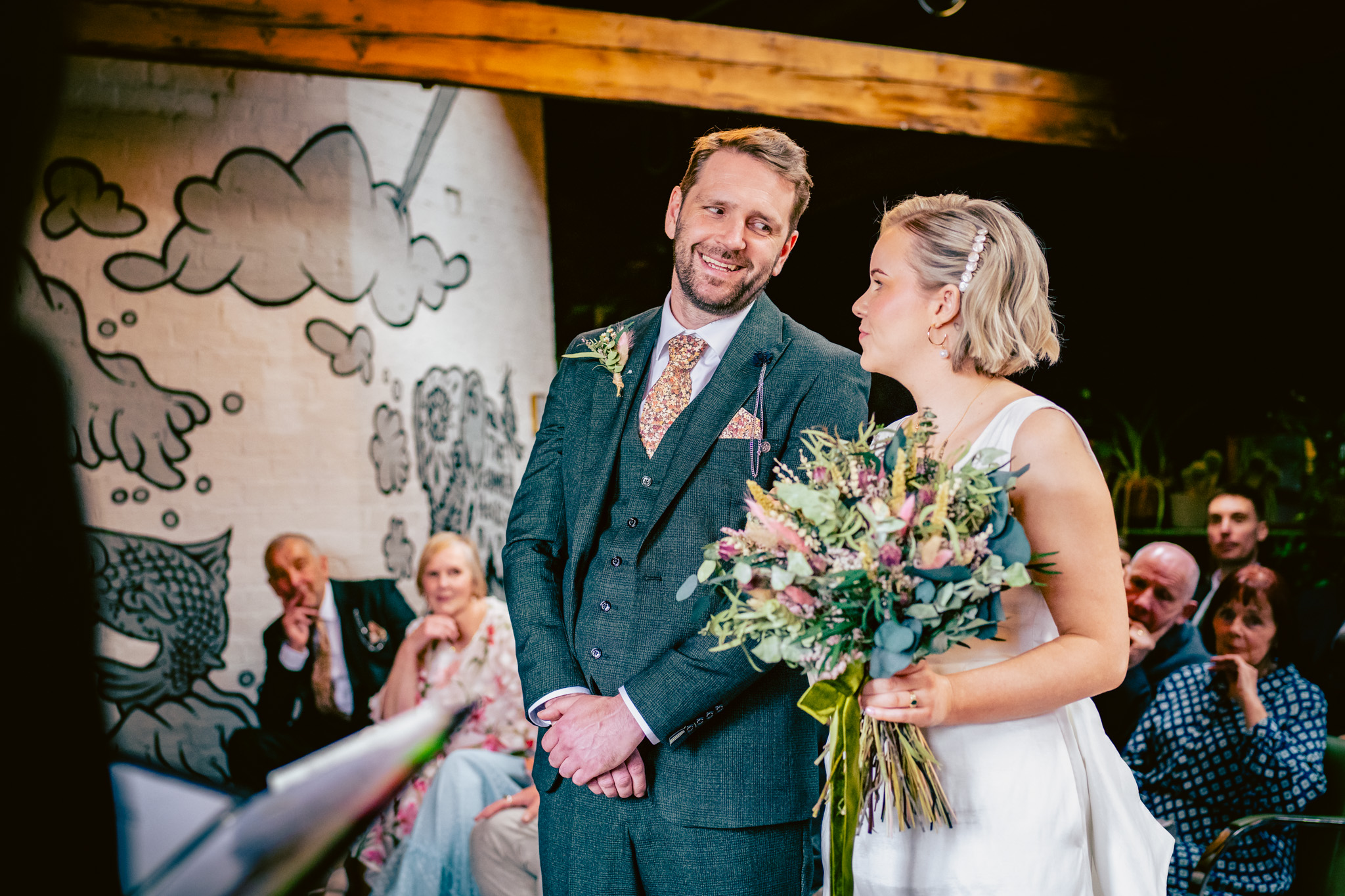 Bride and groom smile at each other at a relaxed Chimney House wedding in Sheffield