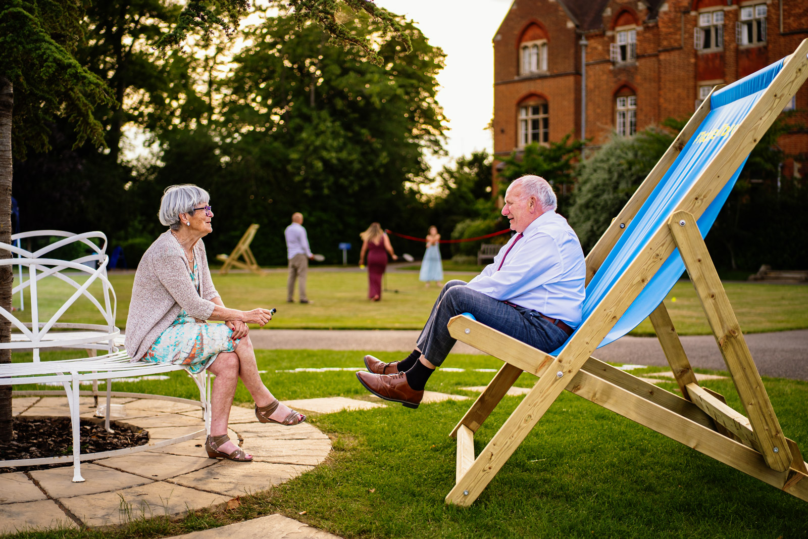 A man sitting in an oversized deckchair at a wedding